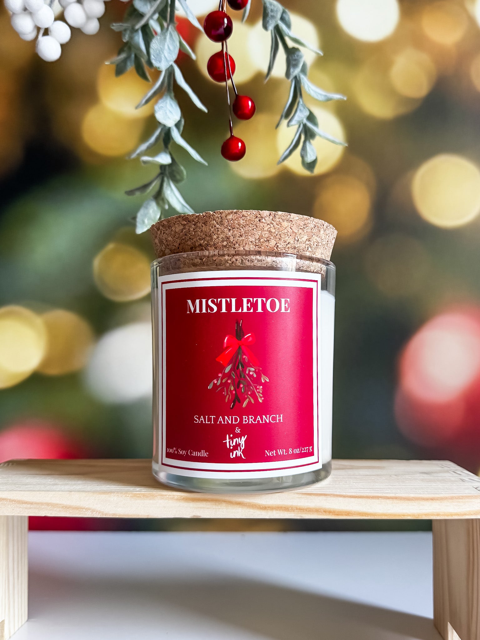 Candle jar scent 'Mistletoe' with a festive holiday background