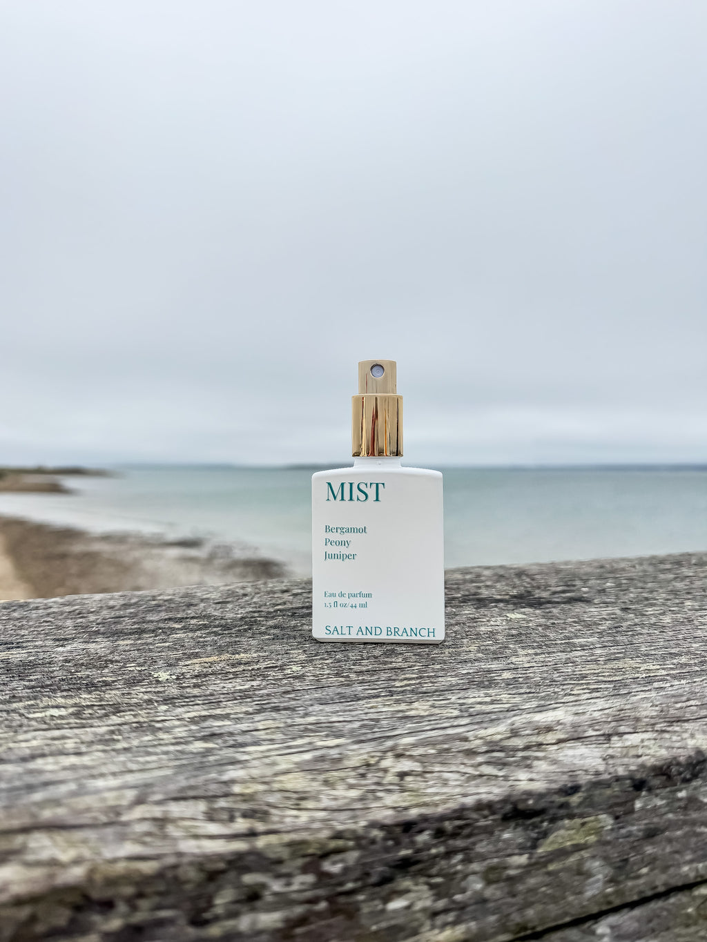 mist perfume bottle on driftwood railing Salt and Branch