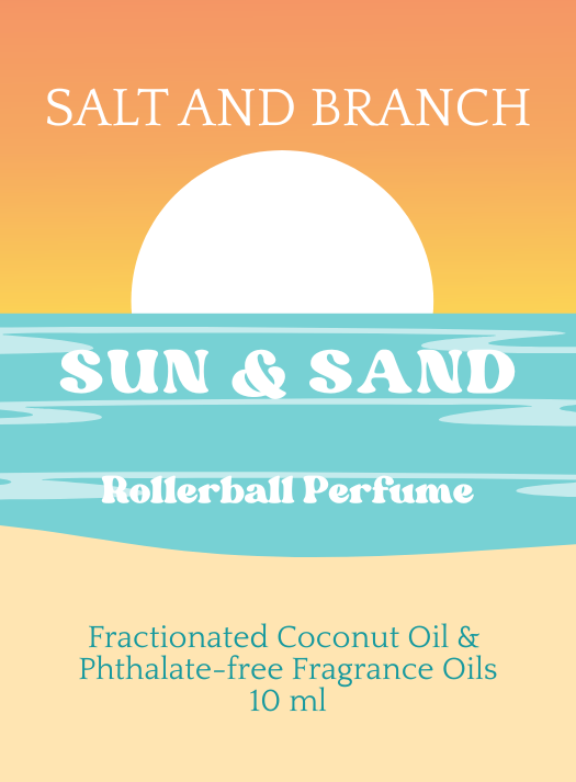 A flat illustrated perfume label reading 'SALT AND BRANCH' at the top, 'SUN & SAND' across a turquoise water band, and 'Rollerball Perfume' below. The design uses a sunset gradient background with peach, orange, yellow, and pale blue tones, plus text noting 'Fractionated Coconut Oil & Phthalate-free Fragrance Oils 10 ml'.