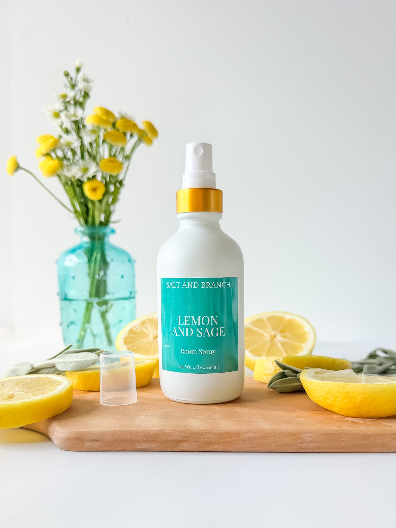 lemon sage room spray bottle with lemons on a cutting board Salt and Branch