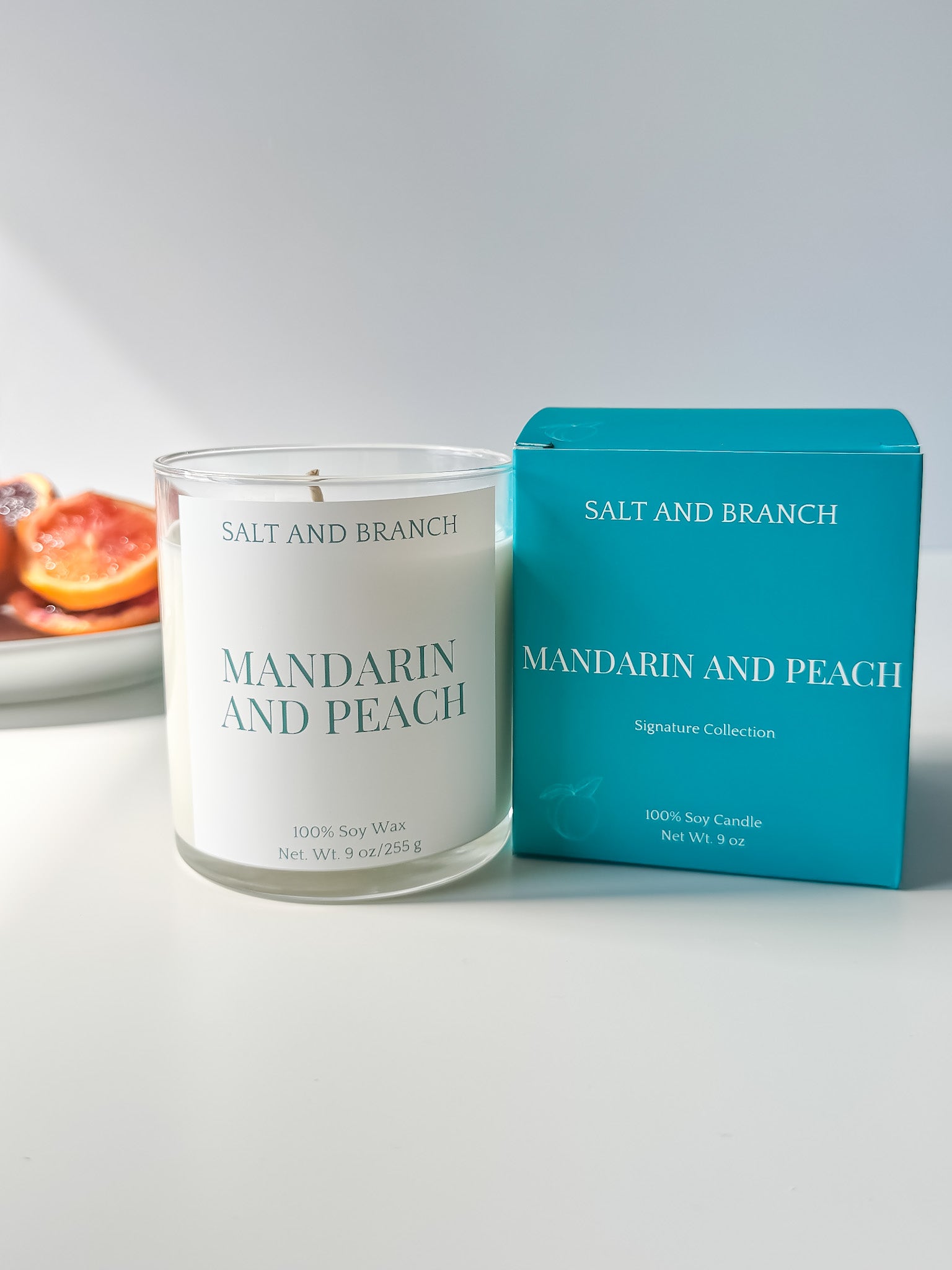Mandarin and Peach Soy Candle white background with orange slices Salt and Branch