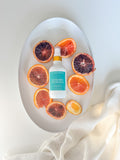 mandarin peach room spray on white tray with orange slices Salt and Branch