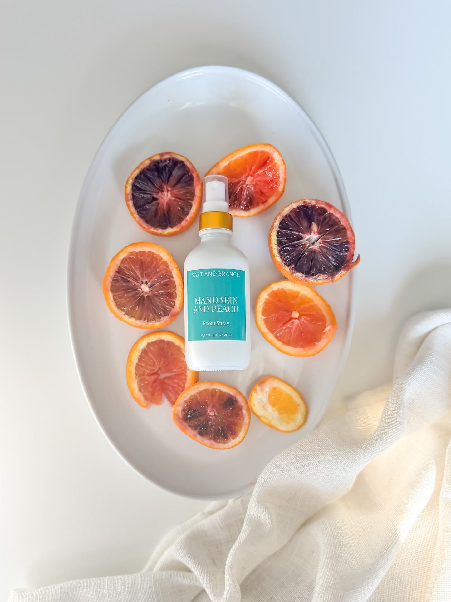 mandarin peach room spray on white tray with orange slices Salt and Branch